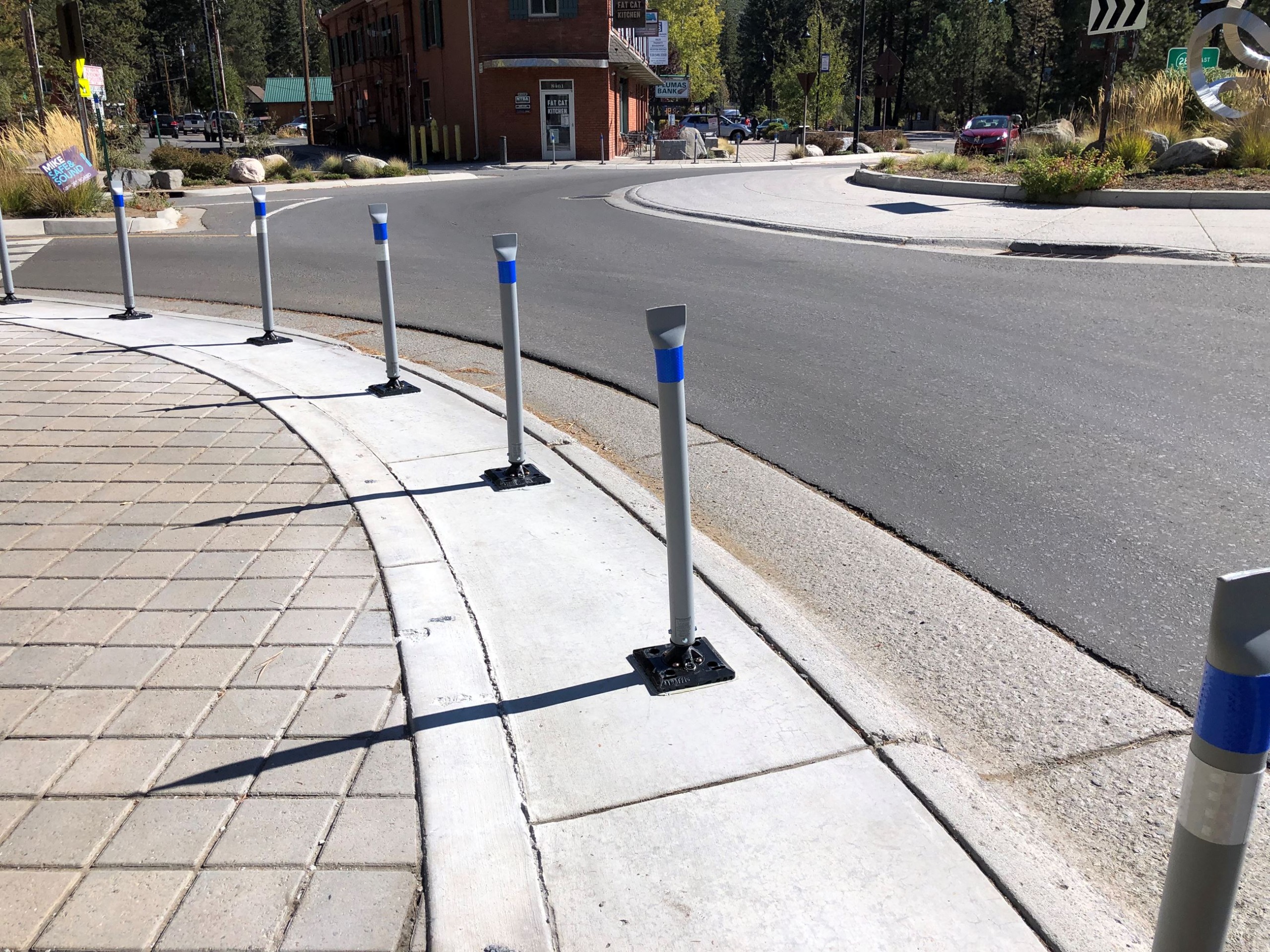 An image of flexible delineators on a sidewalk near a roadway in Kings Beach. 