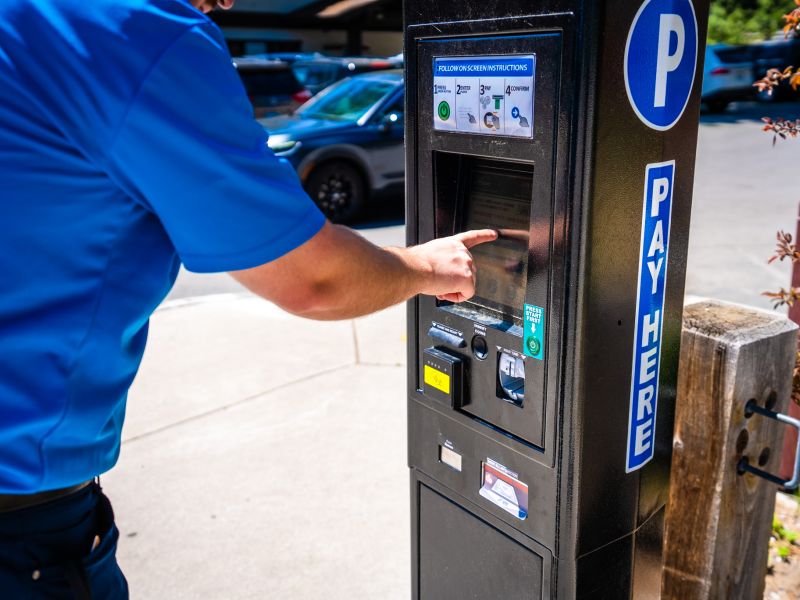 A person touches a paid parking payment screen in Kings Beach. 